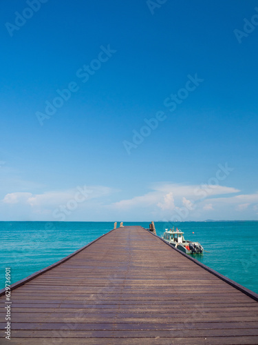 Landscape summer walkway bridge walk sea and also small port. And small boat moored with view of blue sea, clear sky clean, suitable holiday travel At Gulf Thailand Khao Leam Ya National Park Rayong