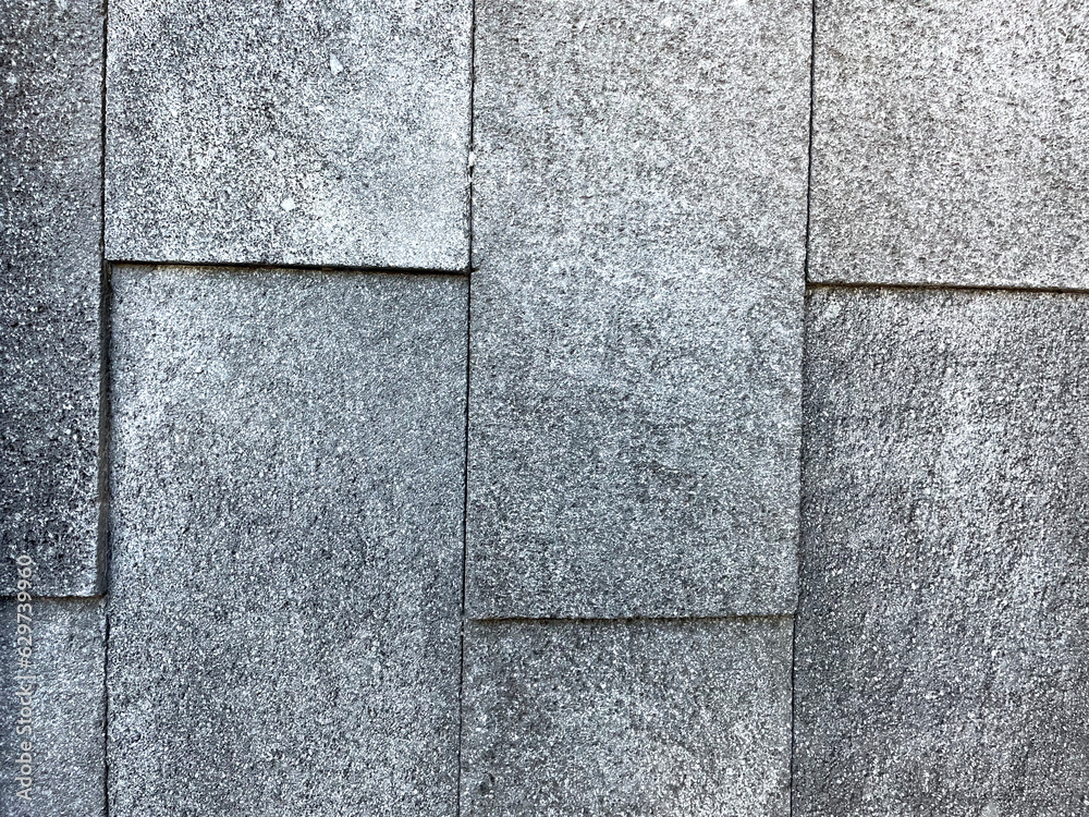 Naklejka premium Texture of laying stones on the ground. Black stone, black with brown stone, cobblestone, construction, stone shadow, dotted rectangular tile for your background