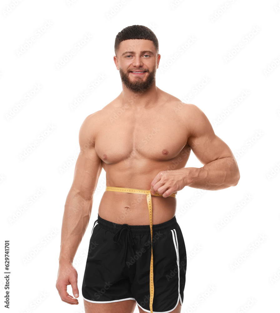 Happy athletic man measuring waist with tape on white background. Weight loss concept Happy athletic man measuring waist with tape on white background. Weight loss concept
