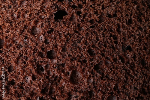 Tasty chocolate sponge cake as background, closeup