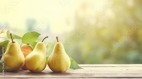 Yellow pears on grey wooden tabletop on blur garden background