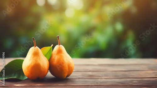 Red pears on grey wooden tabletop on blur garden background