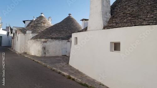 Alberobello Italy - traditional trulli houses with conical stone roofs. Famous landmark, travel destination and tourist attraction near Bari in Puglia, Europe. Street with ancient architecture.