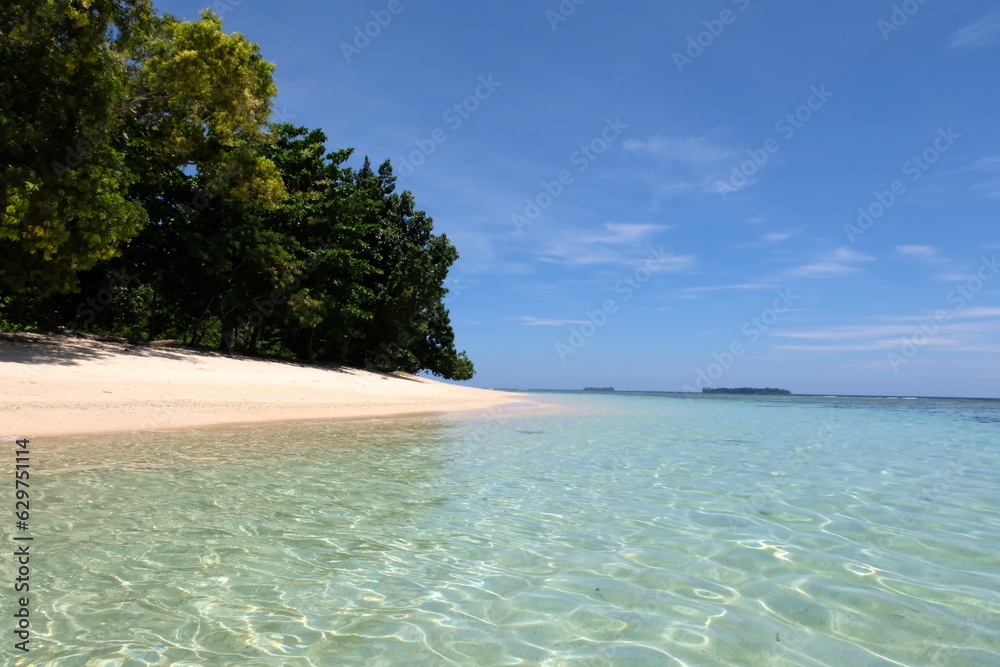 Landscape view of pristine white sandy beach and crystal clear turquoise ocean water in Bougainville, Papua New Guinea