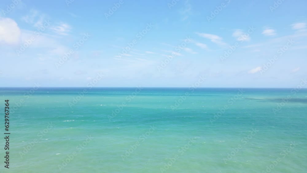 Aerial view blue beach and clouds reflection on the sea surface, natural colors, blue background motion move side way,insert text Aerial view blue beach and clouds reflection on the sea surface, natural colors, blue background motion move side way,insert text