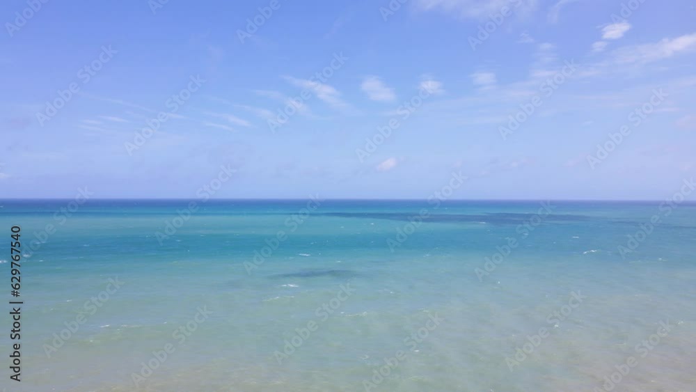 Aerial view blue beach and clouds reflection on the sea surface, natural colors, blue background,insert text. Aerial view blue beach and clouds reflection on the sea surface, natural colors, blue background,insert text.