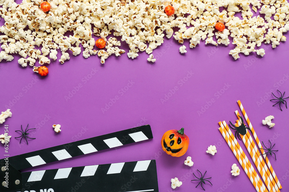 Composition with tasty popcorn, clapperboard and spiders on purple background. Halloween celebration