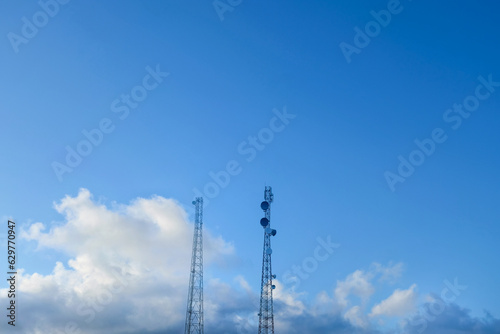 Low-lying clouds adorn the blue sky and appear white to gray in color. clustered and lumpy like cotton. Also visible is the electricity tower. Very beautiful and suitable for background and wallpaper. © Indanya
