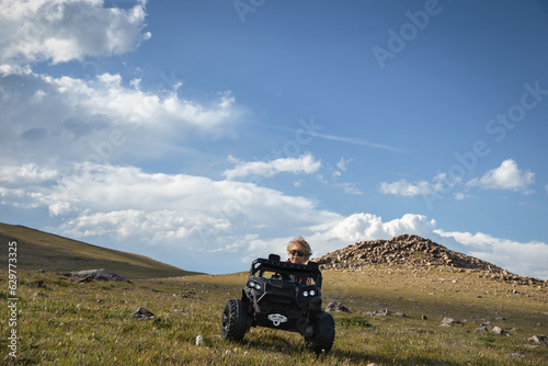 Little boy driving his toy truck on a rocky road trip adventure living and pursuing his dream in the mountains near Red Lodge, MT Cooke City, MT and the Wyoming Border near Yellowstone National Park © TS