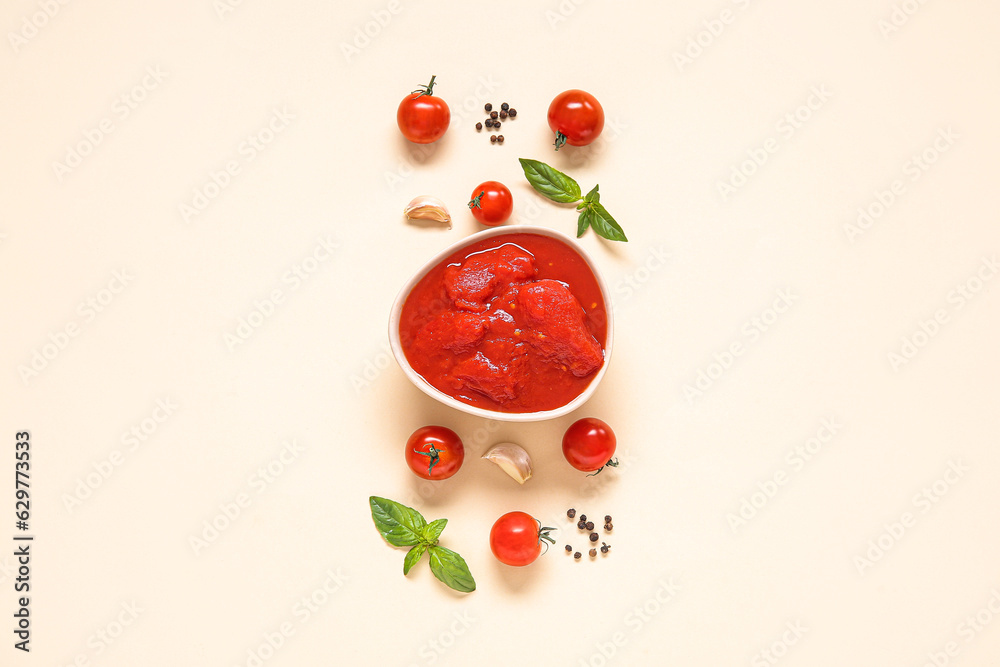 Composition with bowl of tasty canned tomatoes and spices on color background Composition with bowl of tasty canned tomatoes and spices on color background