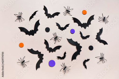 Paper bats and spiders for Halloween party on grey background © Pixel-Shot