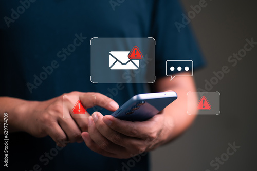 Spam email and virus  concept, man using smartphone with spam email icon,  scammer,  malware, virus.