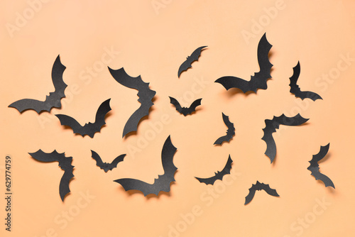 Paper bats for Halloween party on orange background © Pixel-Shot