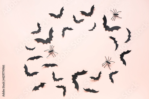 Frame made of paper bats and spiders for Halloween party on pink background © Pixel-Shot