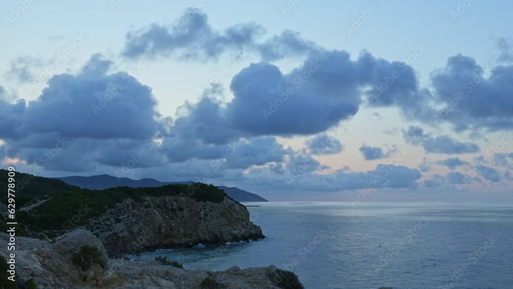 Time lapse captures sea coastline during beautiful sun rise over mountain range Time lapse captures sea coastline during beautiful sun rise over mountain range