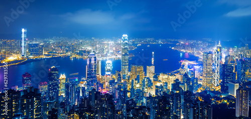 Hong Kong cityscape with victoria harbour and large group of tall buildings at night