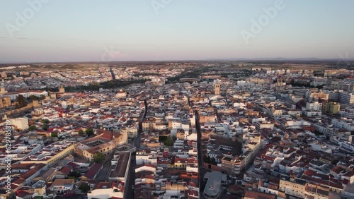 Aerial orbiting shot of Badajoz Cityscape during sunset, Spain photo