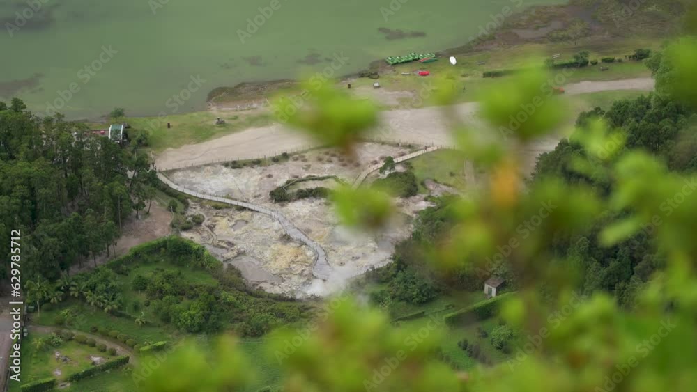 Top view of the hot springs at Furnas Lake, Sao Miguel Island, Azores, Portugal. Fumarolas da Lagoa das Furnas - Pine branches in the foreground Top view of the hot springs at Furnas Lake, Sao Miguel Island, Azores, Portugal. Fumarolas da Lagoa das Furnas - Pine branches in the foreground