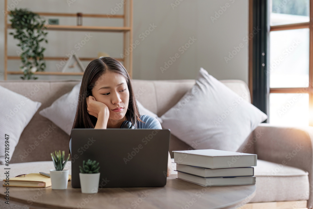 Asian women are bored from their online studies, have a sad face and have been tired from their studies for a long time. Asian women are bored from their online studies, have a sad face and have been tired from their studies for a long time.