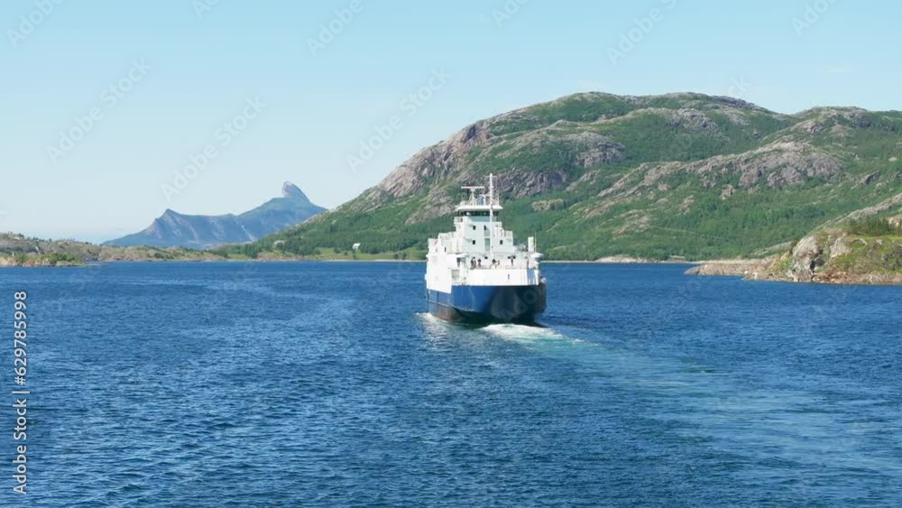 Ferry transport people and cars in arctic Norway fjord with mountain background Ferry transport people and cars in arctic Norway fjord with mountain background