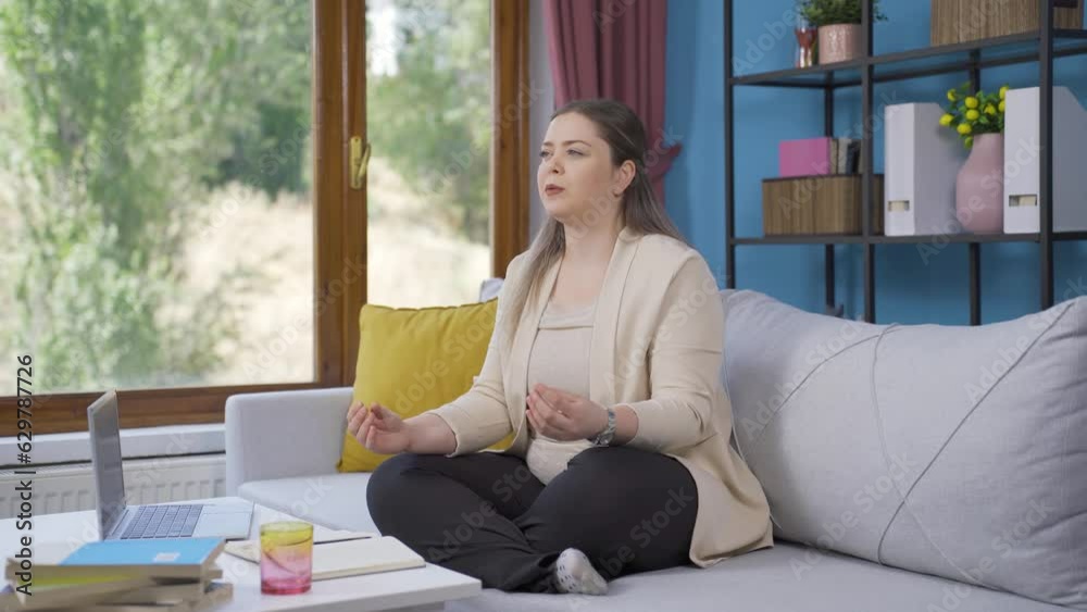 Young woman doing yoga outside in front of the window. Young woman doing yoga outside in front of the window.