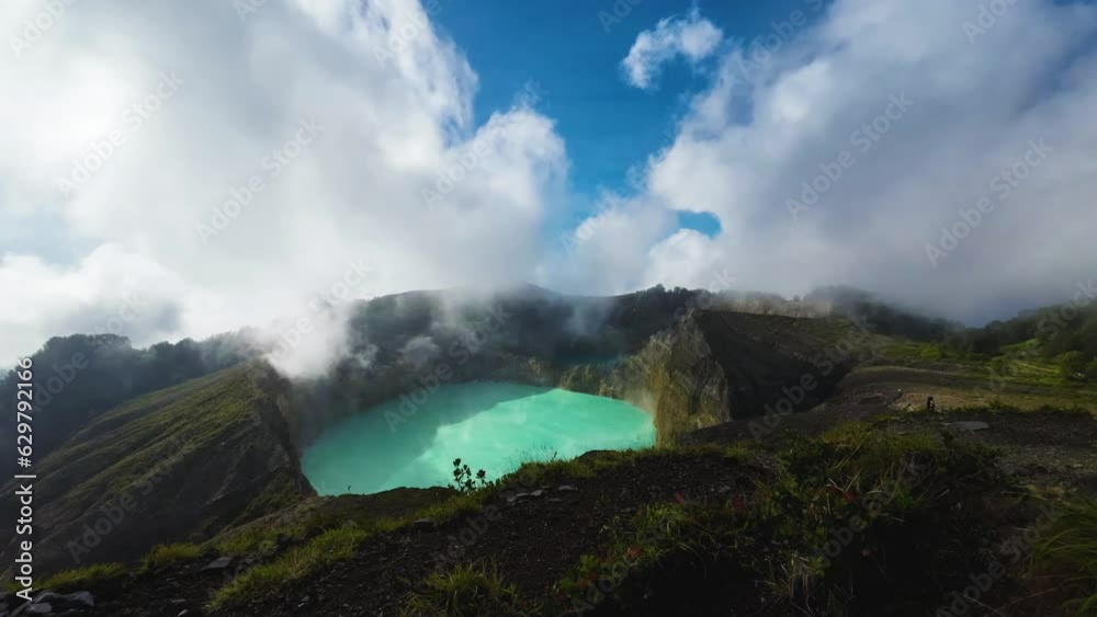 Timelapse at the top of the Kelimutu Volcano overviewing the volcanic crater in Flores Island, Indonesia. Timelapse at the top of the Kelimutu Volcano overviewing the volcanic crater in Flores Island, Indonesia.