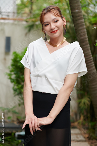 Portrait of smiling elegant transgender woman at outdoor party