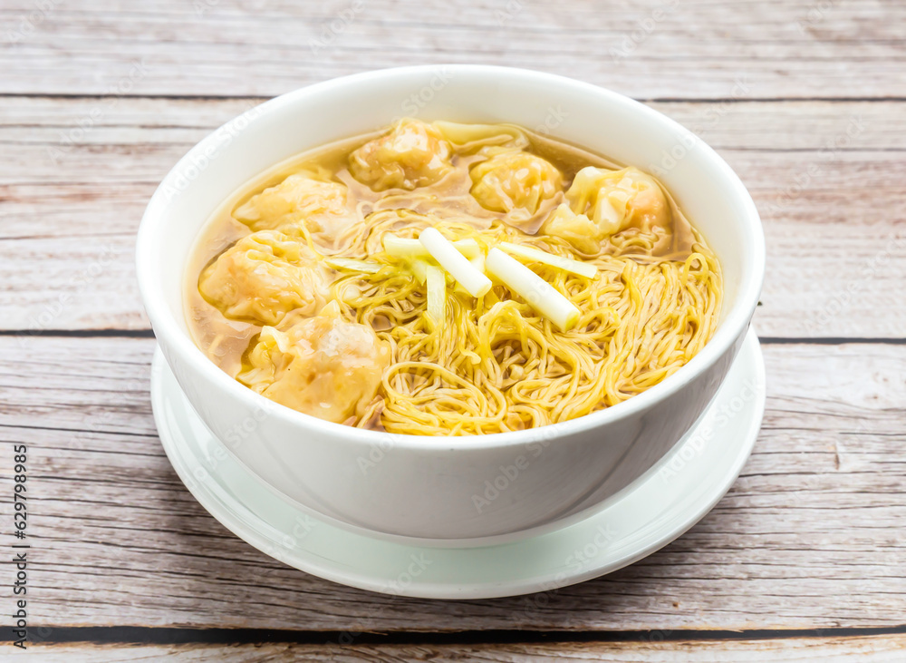wonton noodles soup served in dish isolated on wooden table top view hong kong food wonton noodles soup served in dish isolated on wooden table top view hong kong food