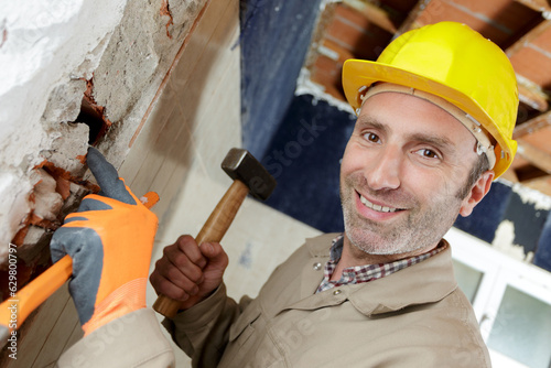 downward view of builder holding sledge hammer photo