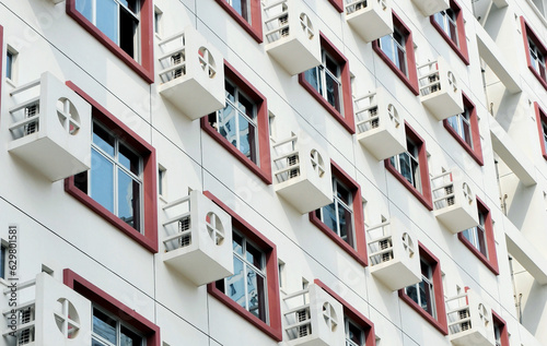 Canvas Print Apartment building wall with large group of air-conditioners, China