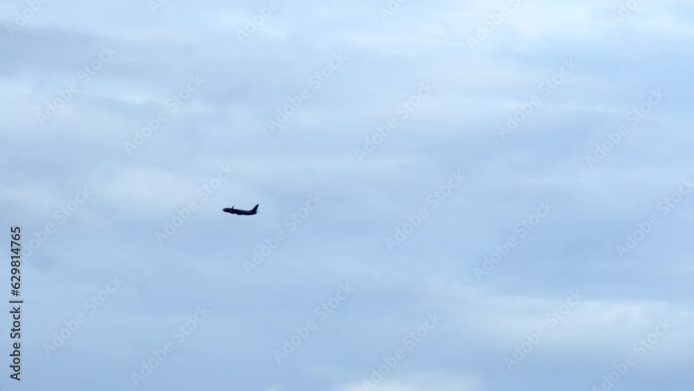 Plane flying in the distance cloudy moody sky long shot silhouette Plane flying in the distance cloudy moody sky long shot silhouette