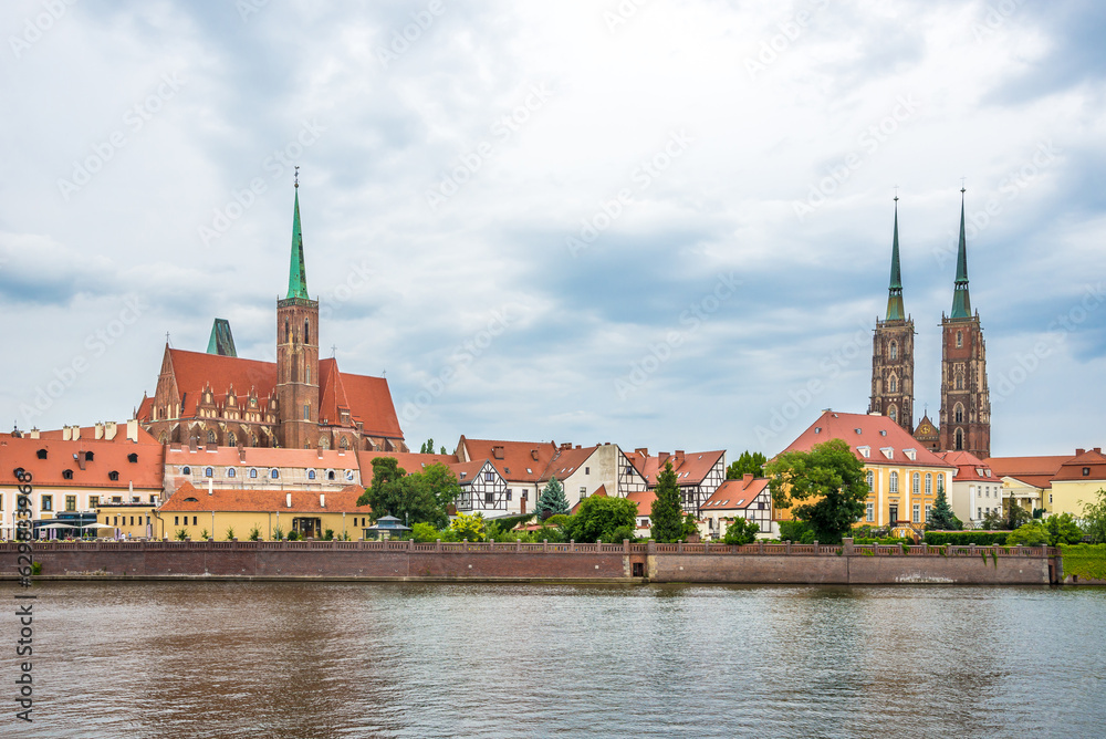 Fototapeta premium View at the Church of Holy Cross and Saint Bartholomew ,cathedral of Saint John the Baptist with Odra rover in Wroclaw