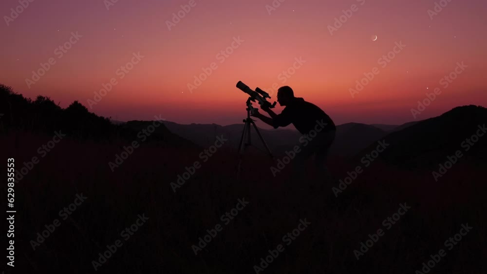 Astronomer looking at the starry skies and crescent Moon with a telescope. Astronomer looking at the starry skies and crescent Moon with a telescope.