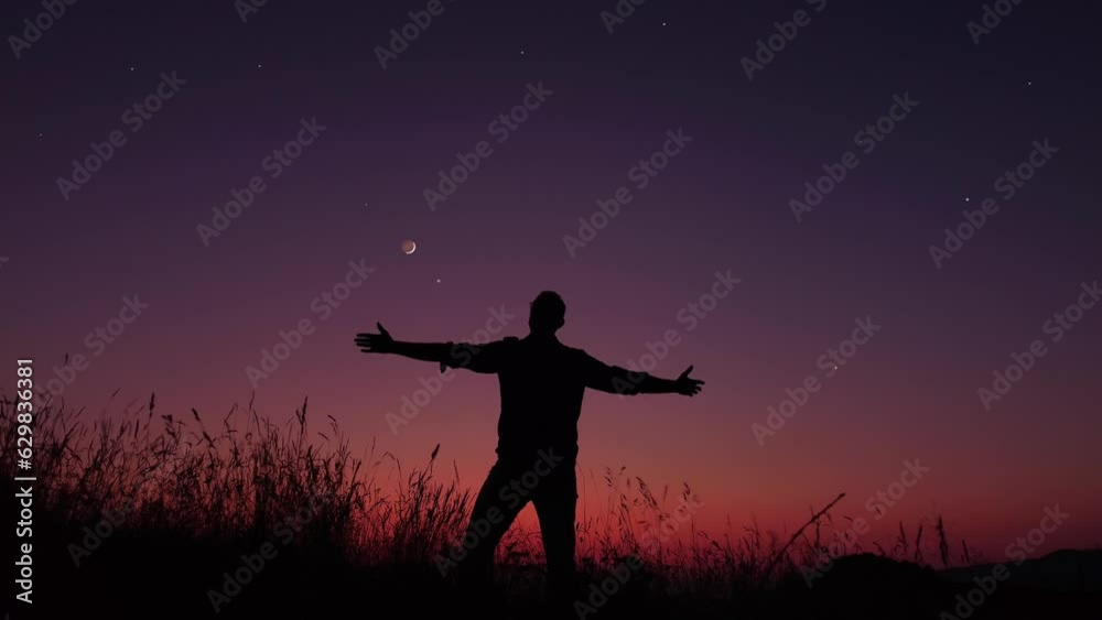 Man with arms wide open enjoying outdoors under stars, planets and Moon. Man with arms wide open enjoying outdoors under stars, planets and Moon.