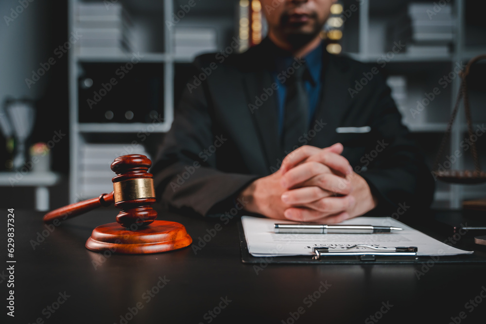 concept of justice and law A male judge in the courtroom on a wooden table and a male counselor or lawyer working in the office. Law, advice and justice concepts. concept of justice and law A male judge in the courtroom on a wooden table and a male counselor or lawyer working in the office. Law, advice and justice concepts.