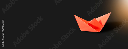 a dark background with a red paper boat It s really difficult to launch a successful firm.   starting a new company