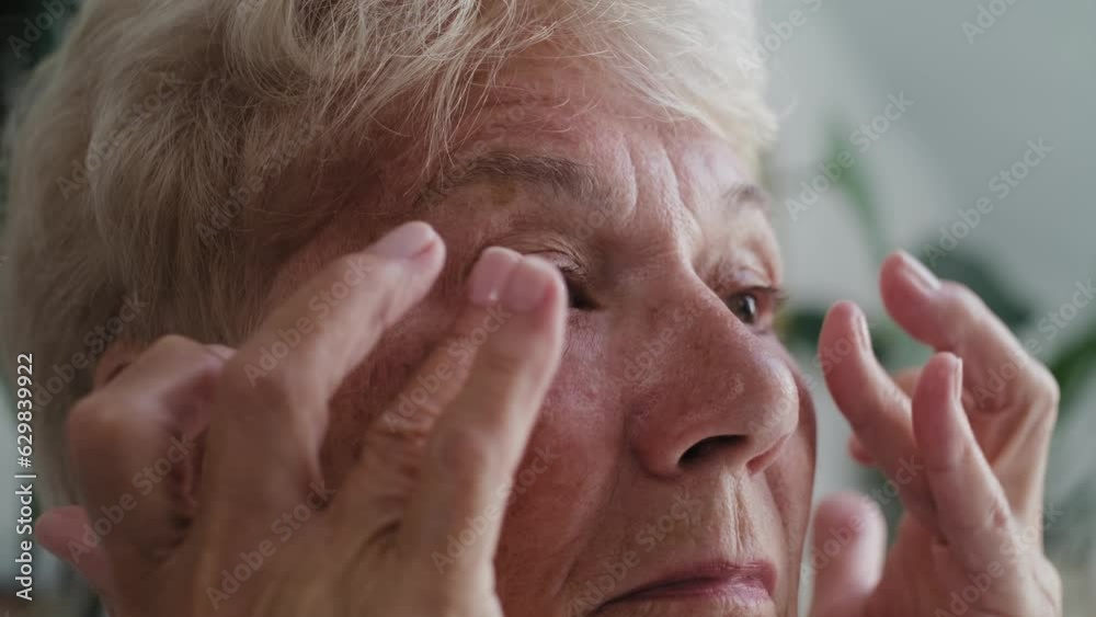 Close up of senior woman checking skin condition around the eye area. Shot with RED helium camera in 8K. Close up of senior woman checking skin condition around the eye area. Shot with RED helium camera in 8K.