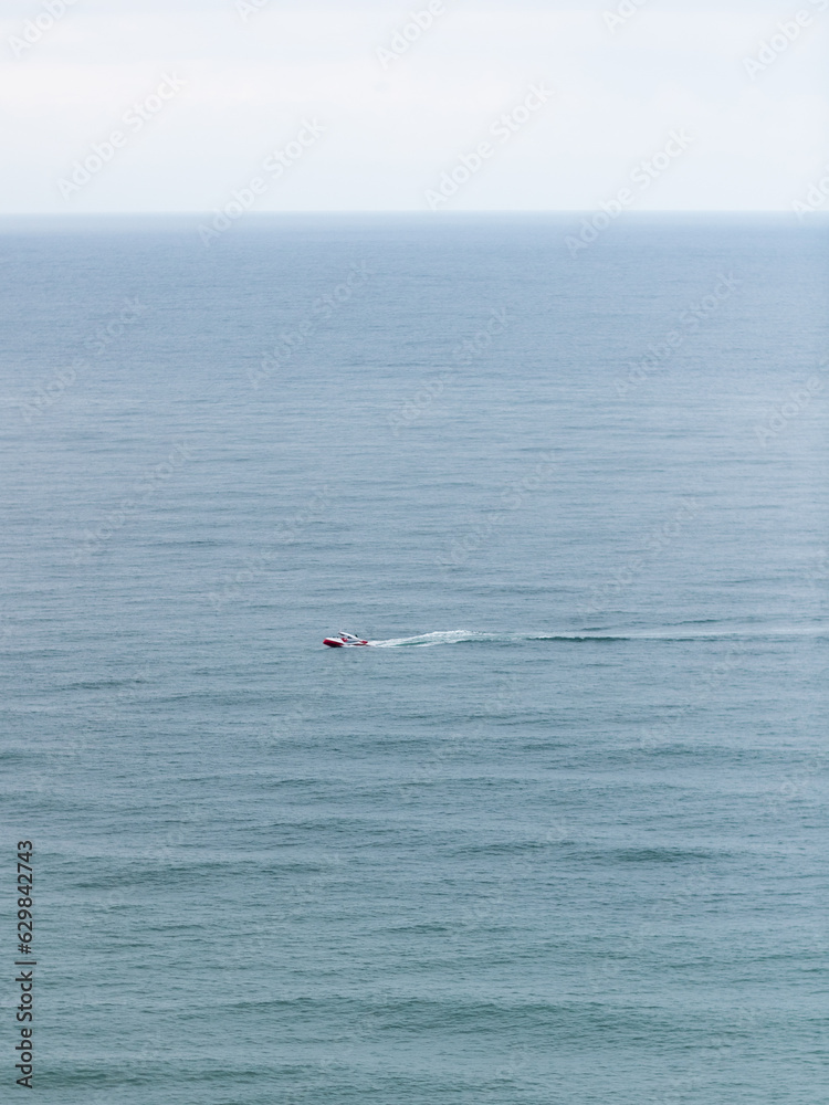 An overhead view of a small boat in a big sea 