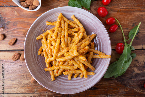 Sicilian pasta with almond and tomatoes pesto. Typical Italian food from Sicily, pasta with red pesto.