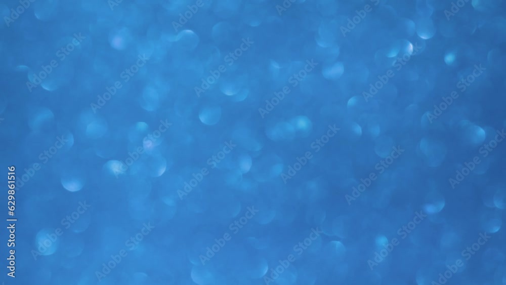 Blue bokeh lights background. Chaotic motion of blurred sparkling blue bokeh circles. Natural effect of defocused glitters. 4K footage. Blue bokeh lights background. Chaotic motion of blurred sparkling blue bokeh circles. Natural effect of defocused glitters. 4K footage.