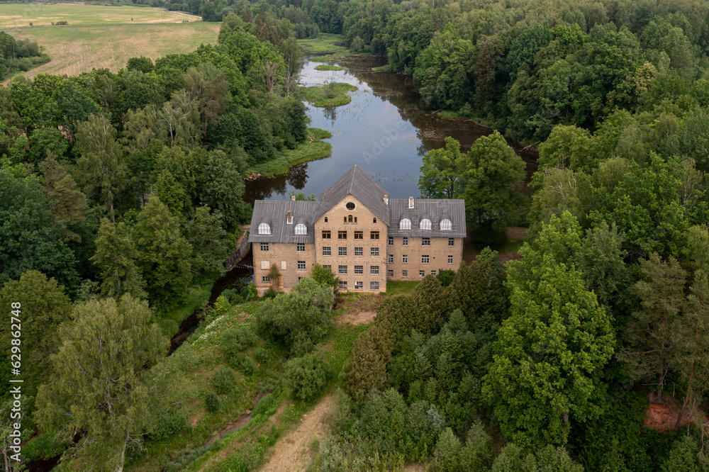The ancient Katrina mill building in a picturesque location by the lake, Krimulda, Latvia