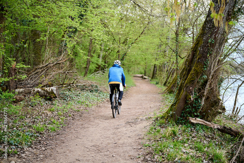Fototapeta Naklejka Na Ścianę i Meble -  person riding a gravel bike on a forest road in France
