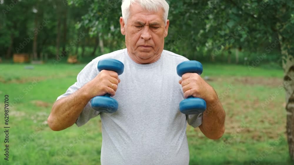 Senior man working out outdoors. Person lifting dumbbells. Old male exercising at park. Healthy people lifestyle. Active sport training. Older elderly sportsman doing fitness exercise. Workout session Senior man working out outdoors. Person lifting dumbbells. Old male exercising at park. Healthy people lifestyle. Active sport training. Older elderly sportsman doing fitness exercise. Workout session