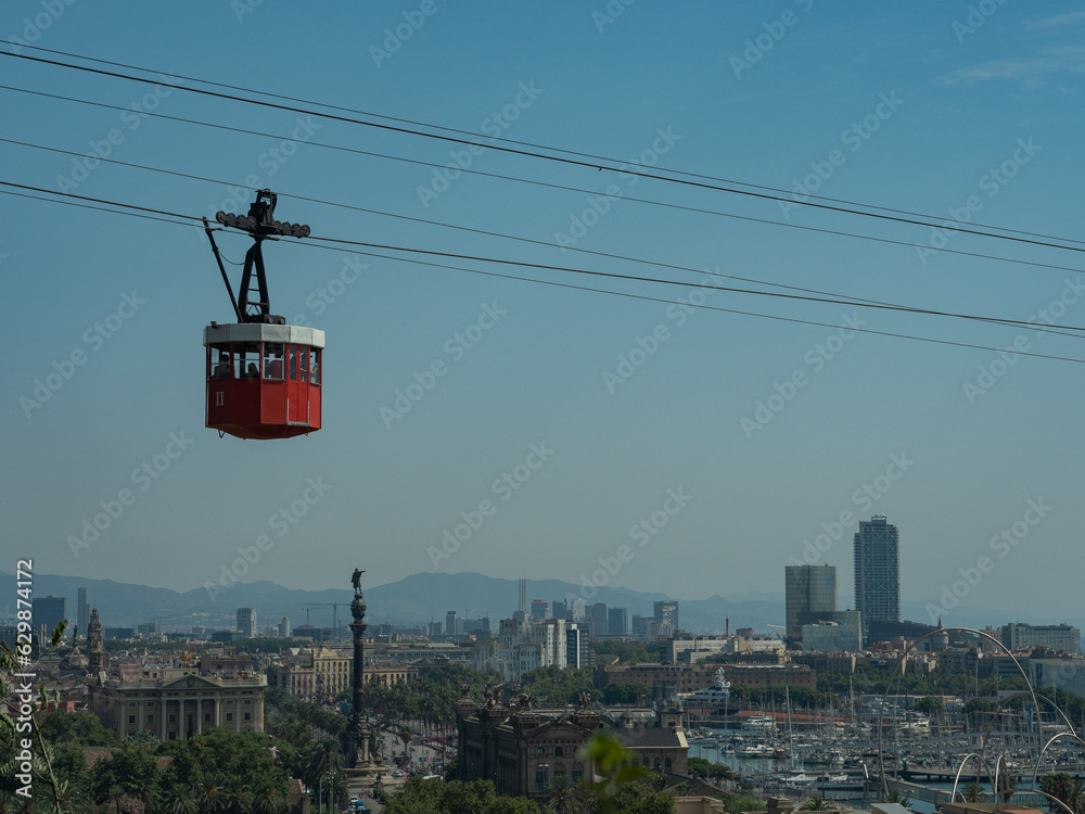 red cable car over barcelona, ​​view of the city from above
