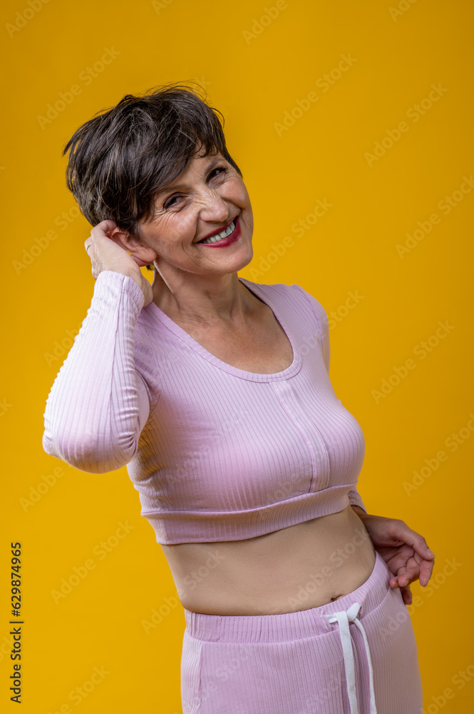 Pretty senior woman in pink looking happy and smiling Pretty senior woman in pink looking happy and smiling