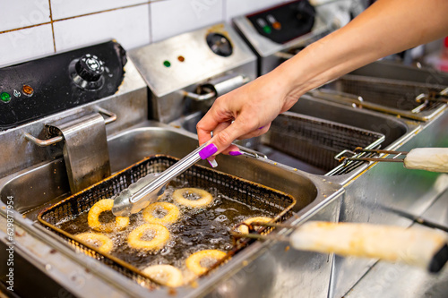 woman chef hand cooking Deep fried onion ring on kitchen