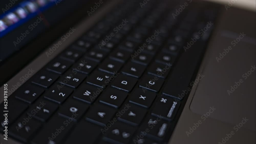 Close up black notebook keyboard with illuminated buttons Close up black notebook keyboard with illuminated buttons