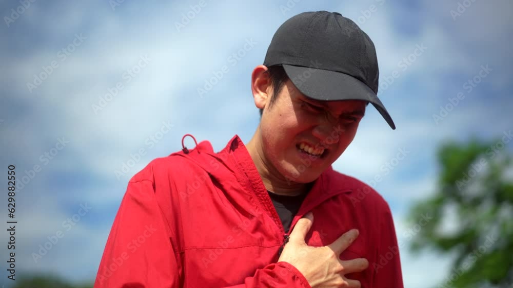 Handsome man tired during jogging and heart attack at sport stadium