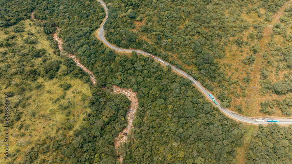 Aerial view of tarmac roading passing the mountain