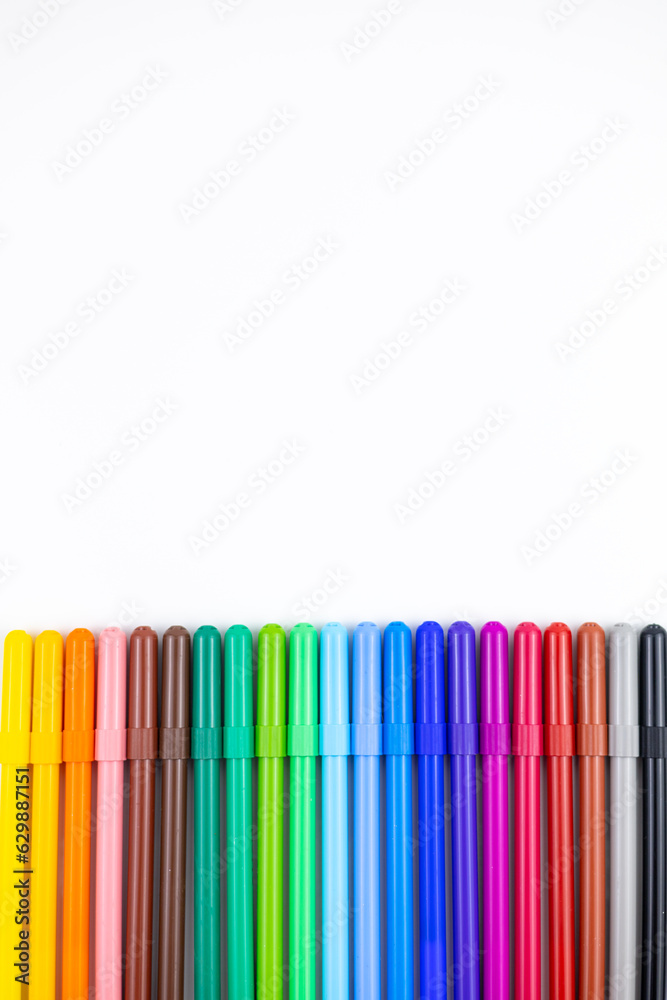 Multi-colored felt tip pens on white background. Back to school colorful banner. Copy space. Multi-colored felt tip pens on white background. Back to school colorful banner. Copy space.